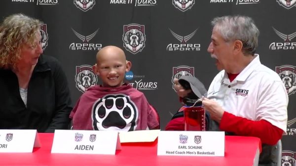 Aiden smiles from ear to ear at the basketball press conference
