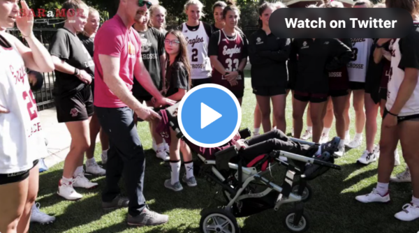lacrosse players surrounding a child in a stroller